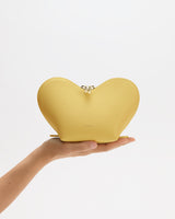 Heart-shaped bag held on a person's hand.