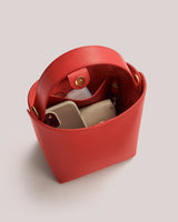 Open handbag with phone and small items inside.