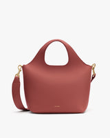 Handbag with short handle and detachable strap.