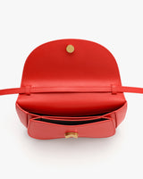 Open belt bag with a flap and visible button inside.