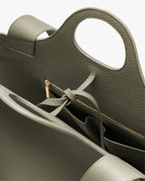 Open handbag with zipper and compartments visible.
