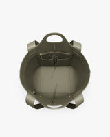 Open handbag with pockets and handles viewed from above.