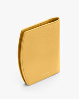 Textured leather wallet standing upright on a white background.