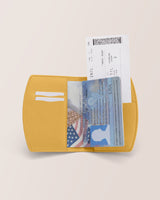 Open passport holder with passport and boarding pass visible.