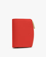 A small wallet with a zipper closure stands upright.