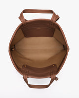 Open travel tote bag with handles and interior pocket.