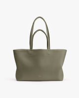 Large tote bag with long handles on white background.