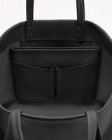 Open handbag showing inside pocket and straps.