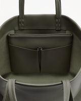 Open handbag with inner pocket and two handles visible.
