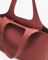 Leather tote bag with wide handles and a spacious interior pocket.