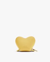 Heart-shaped coin purse on a plain background