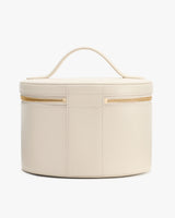 Round cosmetic case with handle and zipper closure.