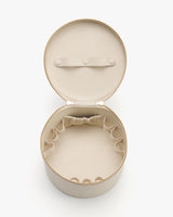 Round open travel case with elastic pockets inside.