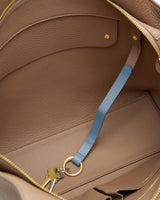 Open bag showing interior with a key attached to a strap.