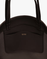 Bag with two handles and outside pocket with gold text.