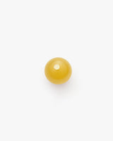 Round candle viewed from above on plain background.
