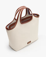 Tote bag with handles and a small label at the bottom.