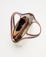 Open handbag containing sunglasses and a wallet viewed from above