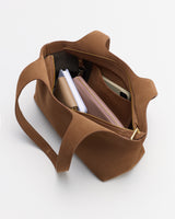 Open handbag with books and a wallet visible inside.