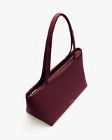 Rectangular handbag with long handles and a zipper on top.
