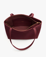 Open tote bag with long handles and inner zipper pocket.