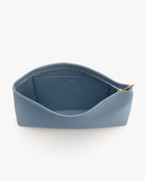 Open zippered pouch with textured interior and visible gold zipper detailing.