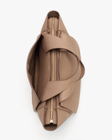 Top view of an open handbag with a zipper closure and shoulder straps.