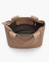 Open travel bag showing inner compartment and handles.