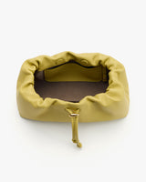 Soft clutch bag with open drawstring and interior pocket.