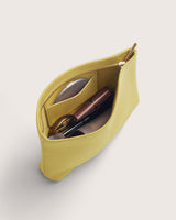 Open makeup bag with various items inside.