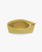 Pouch with zipper partially open revealing inner compartment.