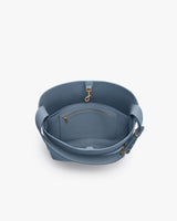 Open handbag with inside zipper pocket and shoulder strap.