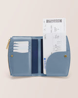 Open wallet with cards and a flight ticket visible inside.
