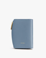 Compact textured wallet with a zipper closure on the side.