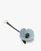 Keychain with a flower design and a loop for attachment.