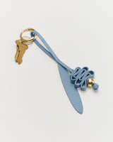 Keychain with keys and decorative leather strap.