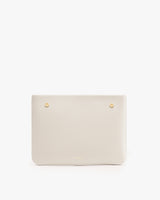 Rectangular leather bag with two gold button details.
