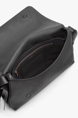 Open handbag displaying interior pockets and zipper.