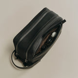 Open handbag with sunglasses and a wallet inside.