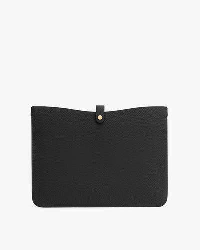 Black textured clutch bag with flap closure and button fastener.