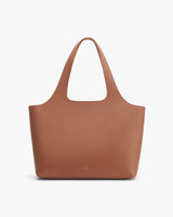 Leather tote bag against a plain background.