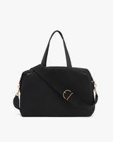 A travel bag with a shoulder strap and top handles.