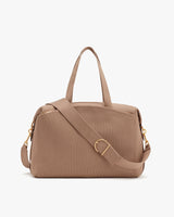 Travel bag with handles and an adjustable shoulder strap.