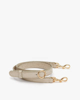 Handbag strap with clasps and a circular ring.