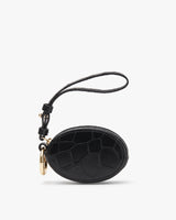 Small oval-shaped bag with a wrist strap and metal clasp.