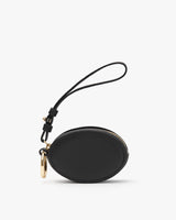 Small round purse with wrist strap and zipper closure.