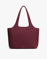 Large tote bag with shoulder straps on plain background