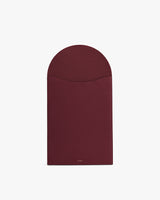 Rectangular leather laptop sleeve with a curved flap closure.