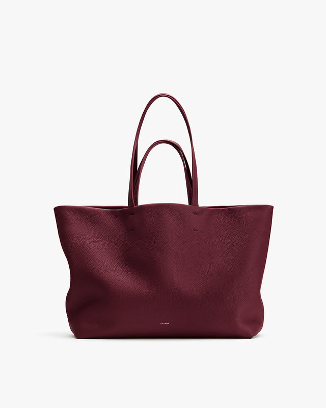 Large tote bag with handles displayed on a plain background