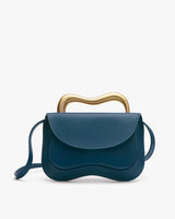 Handbag with unique wavy metal handle and curved flap design.